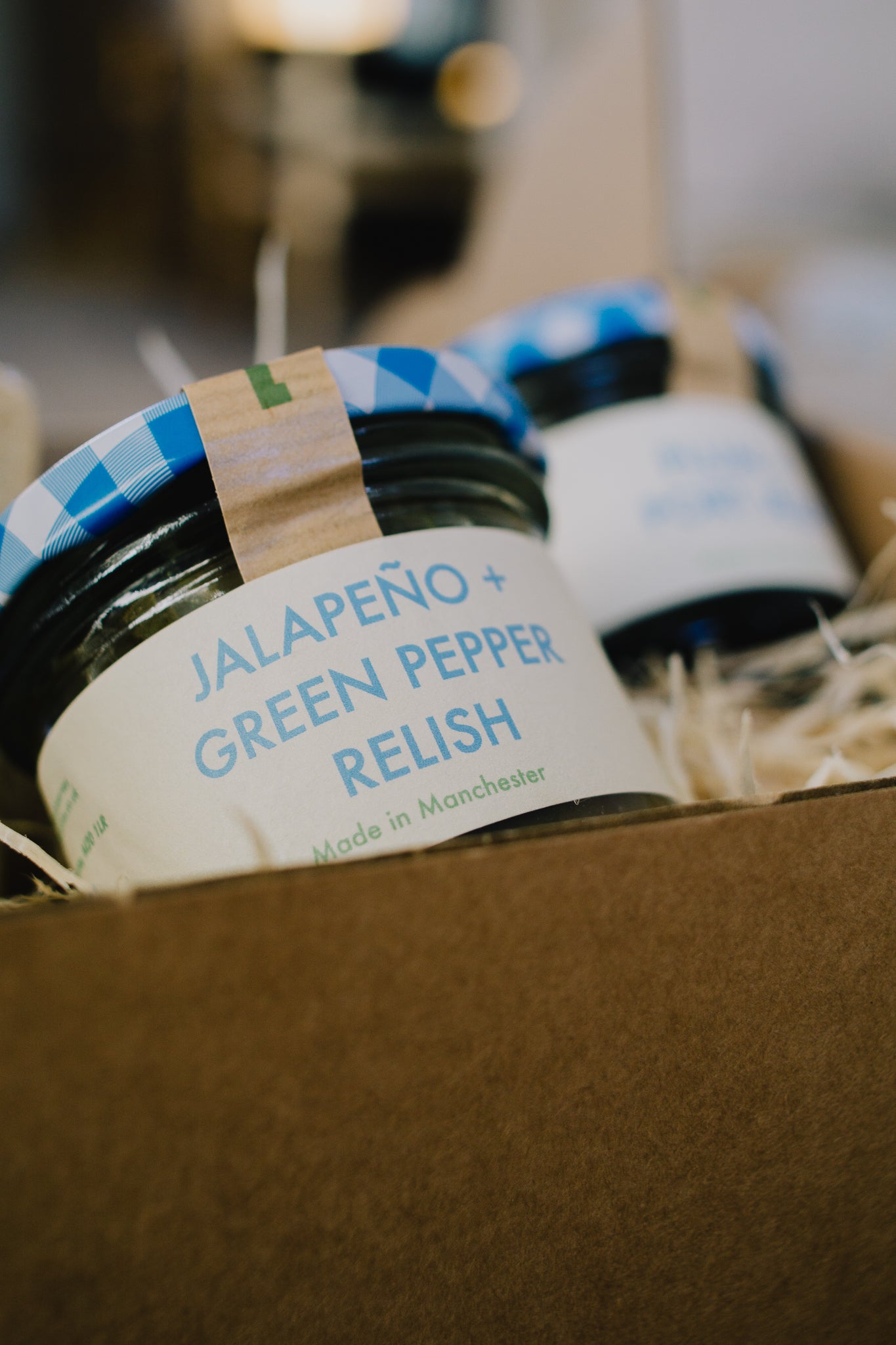 Festive cheeseboard Box containing Oatcakes, jelly, and jalapeño green pepper relish. Perfect gift for cheese lovers. 